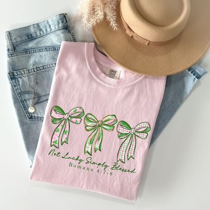 Not Lucky Simply Blessed Shirt, Christian St Patrick’s Day Tee, Romans 4:7-8 Bible Verse Shirt, Faith Bow Graphic Tee, Lucky Charm T-Shirt