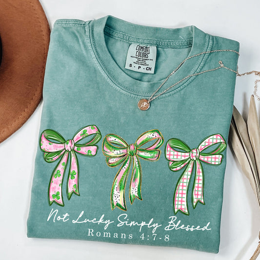 Not Lucky Simply Blessed Shirt, Christian St Patrick’s Day Tee, Romans 4:7-8 Bible Verse Shirt, Faith Bow Graphic Tee, Lucky Charm T-Shirt